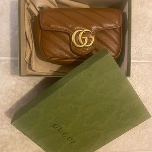 Gucci, brown color, Ones used ,excellent condition ,comes with box and dust bag.